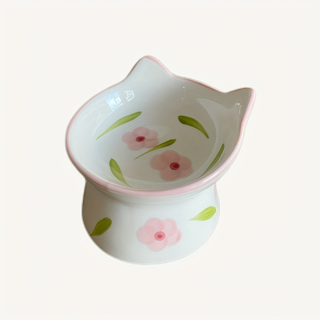 Ceramic cat-shaped bowl with floral designs on a white background