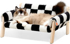 Cat lounging on a black and white checkered pet bed with wooden frame