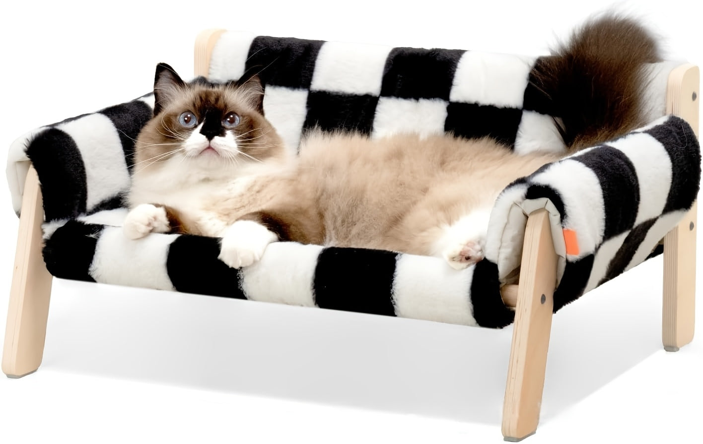 Cat lounging on a black and white checkered pet bed with wooden frame