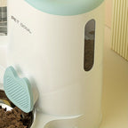 Pet food dispenser with a bowl of food on a light-colored surface