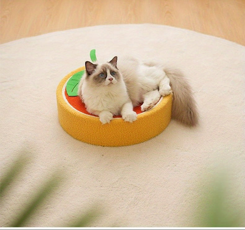 Cat lying on a round, yellow pet bed with a leaf design against a white curtain background.