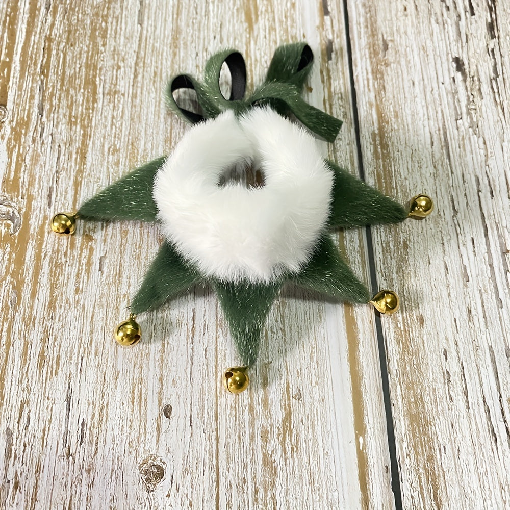 Decorative green star with white center and gold bells on a wooden surface