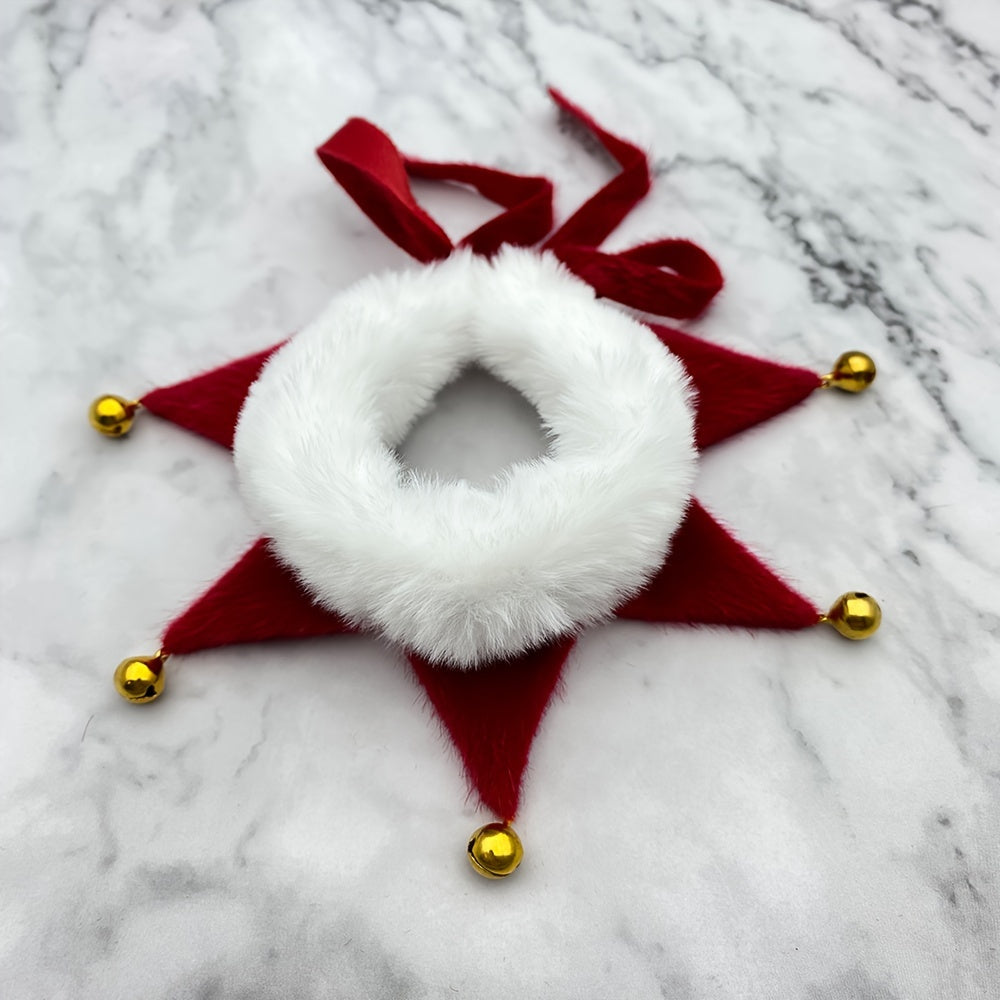 Decorative red and white star-shaped object with gold bells on a marble surface