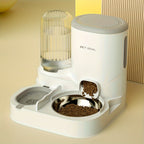 Pet food dispenser with a water bottle on a beige surface