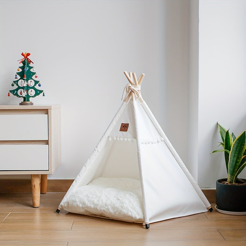 White pet teepee on a wooden floor with a decorative Christmas tree and plant in the background.