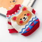 Cartoon bear sweater with red collar and heart patterns on a white background