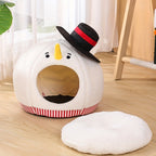 Snowman-shaped pet bed with a black hat on a wooden floor