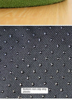 Textured black plastic sheet with non-slip surface on a wooden surface