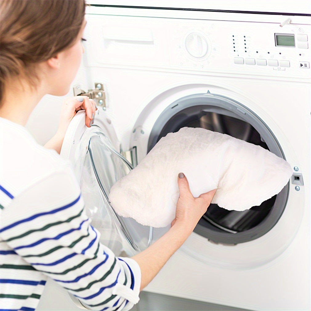 Person placing a pillow into a washing machine