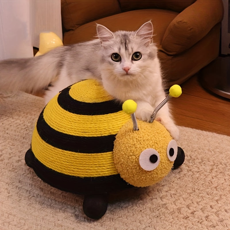 Cat playing with a bee-shaped toy on a carpeted floor.