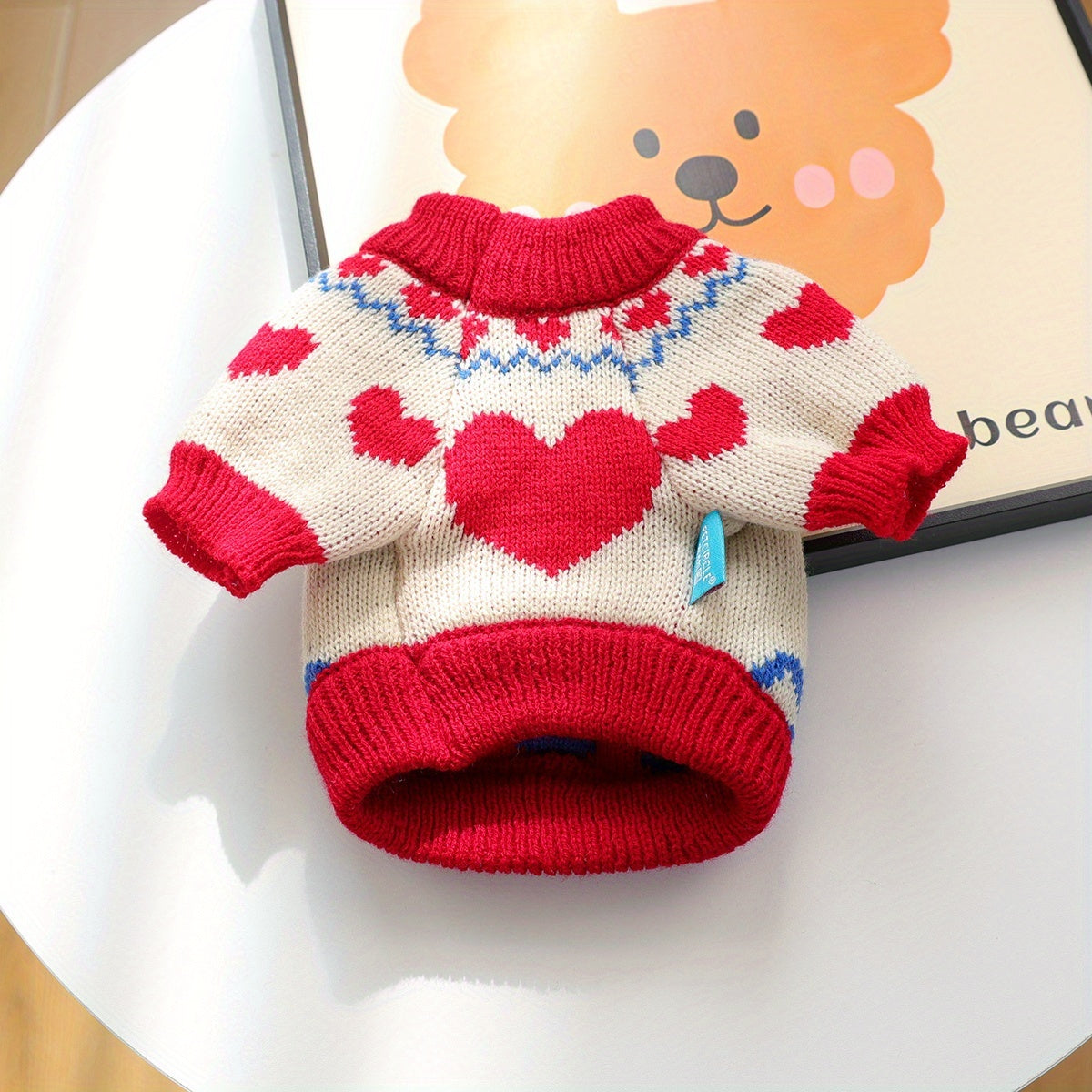 Dog sweater with heart pattern on a white surface