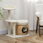 Cat playing with a wicker basket inside a cat tree on a wooden floor.
