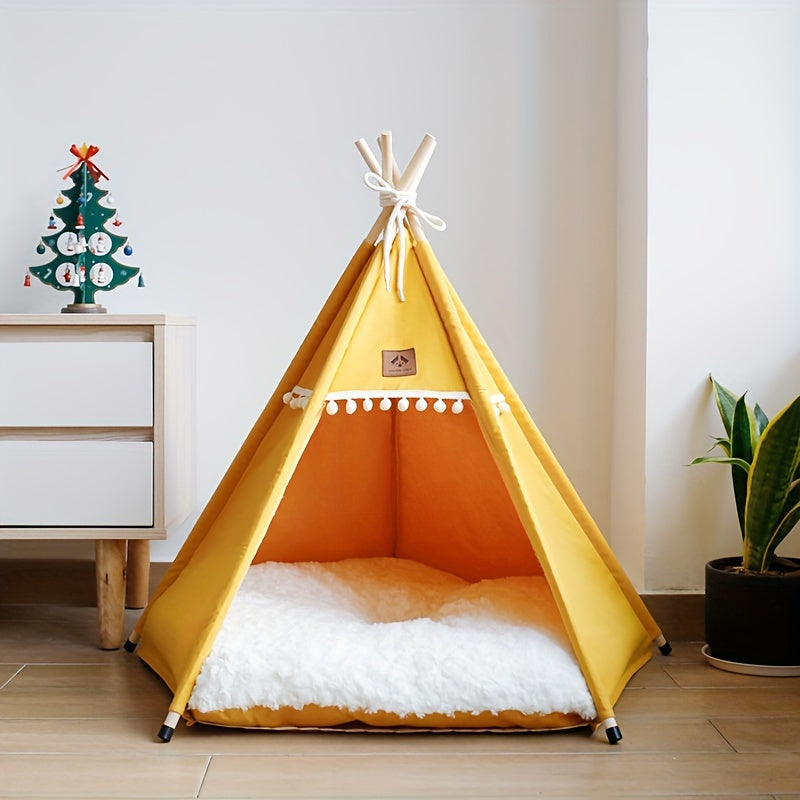 Yellow pet teepee with white interior on a wooden floor, next to a small Christmas tree decoration.