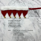 Measurement chart for red decorative trim with gold beads on a marble background