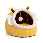 Yellow pet bed designed like a bee with antennae and a flower on a white background