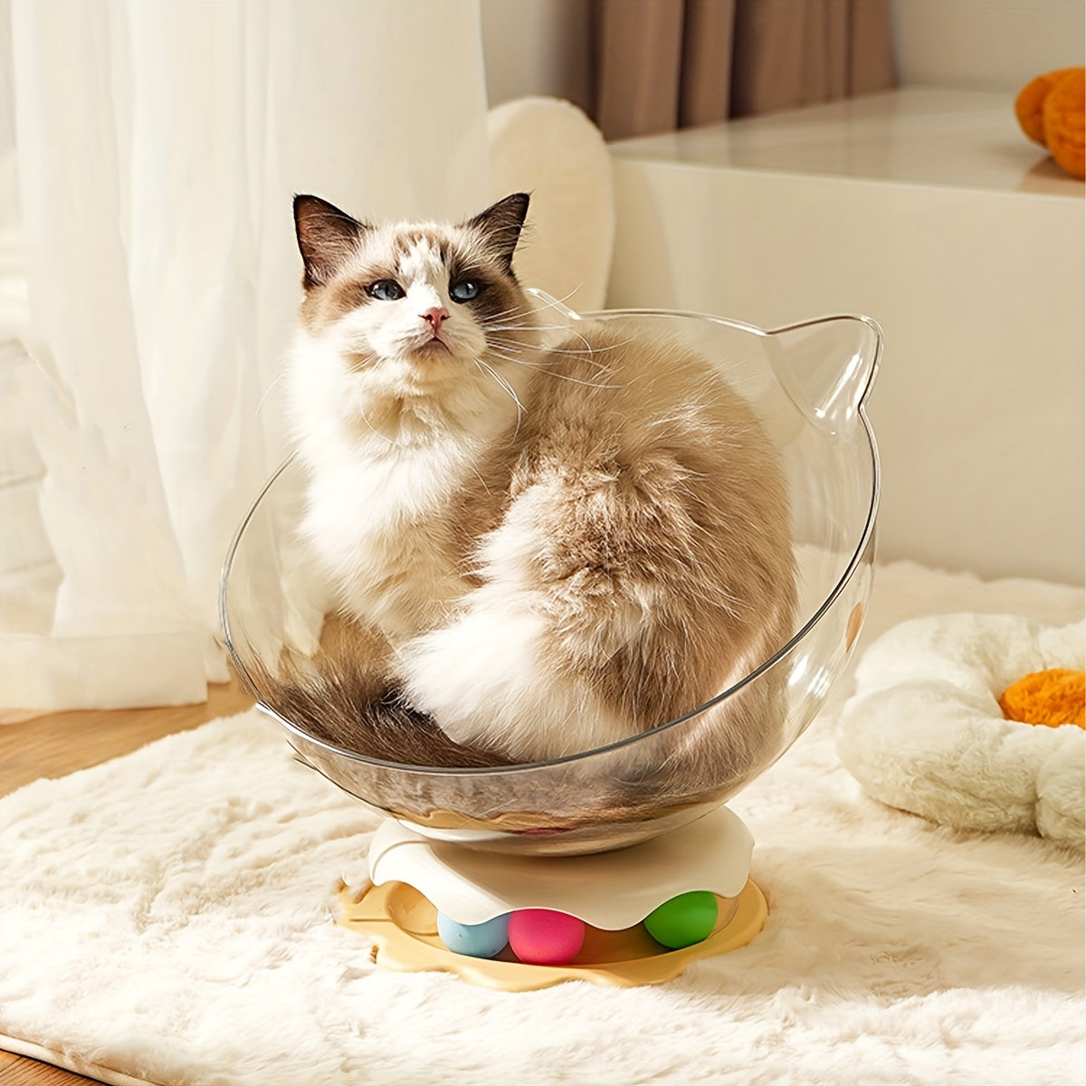Cat sitting in a transparent cat-shaped pet bed on a soft surface.