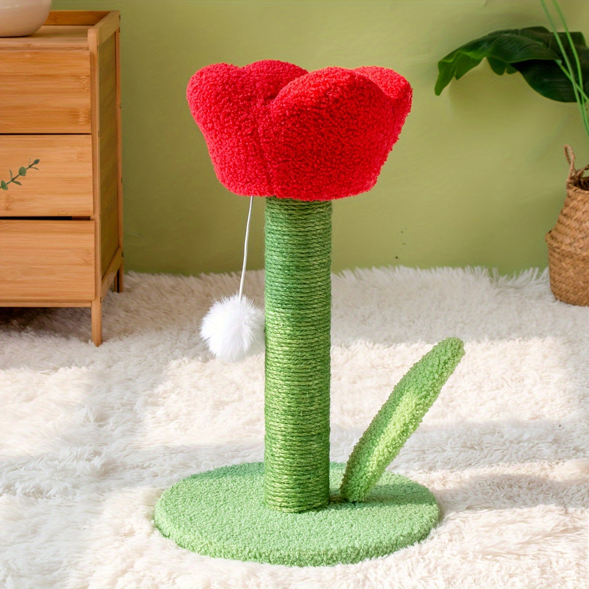 Cat toy shaped like a red flower with green stem and base on a white carpet.