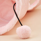 Pink fluffy hair tie on a soft pink background