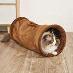 Cat inside a brown plush tunnel on a wooden floor