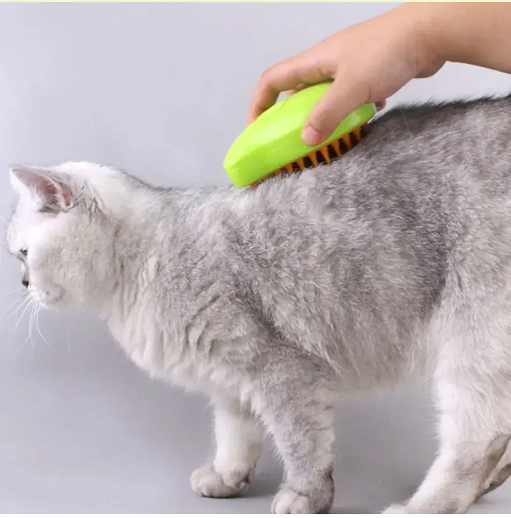 Person grooming a cat with a green brush on a light gray background