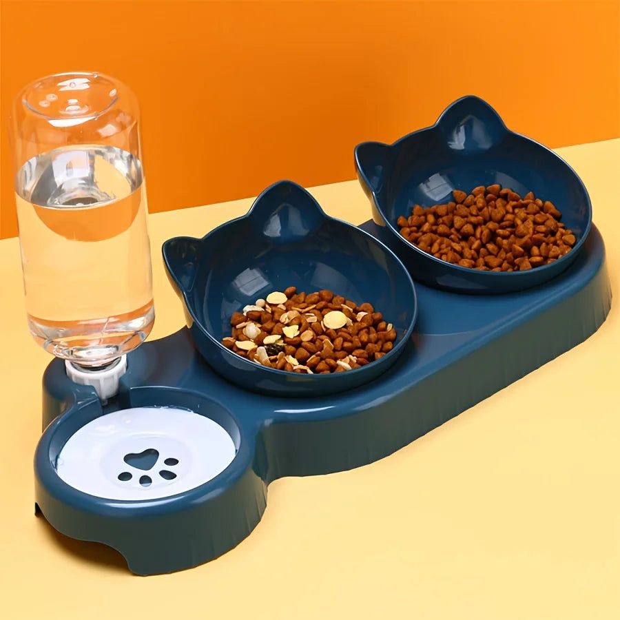 Pet feeding station with two bowls of food and a glass of water on a yellow surface.