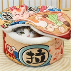 Cat peeking out from a colorful cat bed designed like a bowl of ramen.