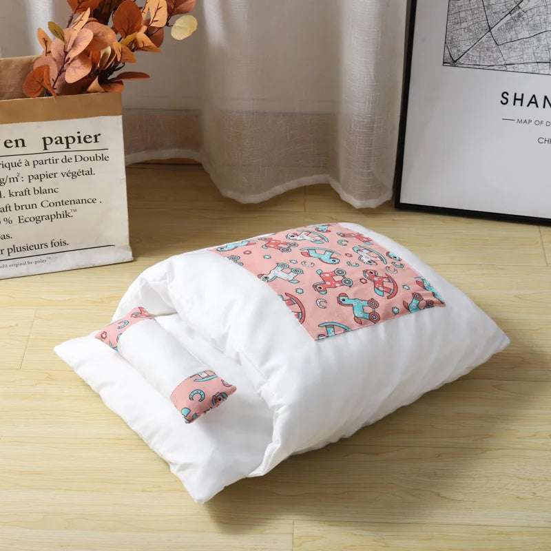 White pillow with pink cartoon-patterned cover on a wooden floor.