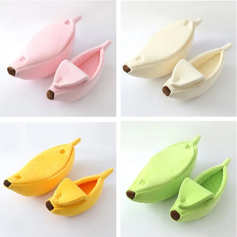 Four banana-shaped slippers in pink, white, yellow, and green on a white background.