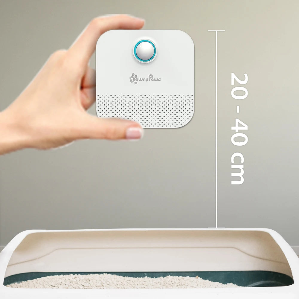 Hand holding a small white device with measurement details on a gray background