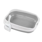 Gray pet litter box with a scoop on a white background