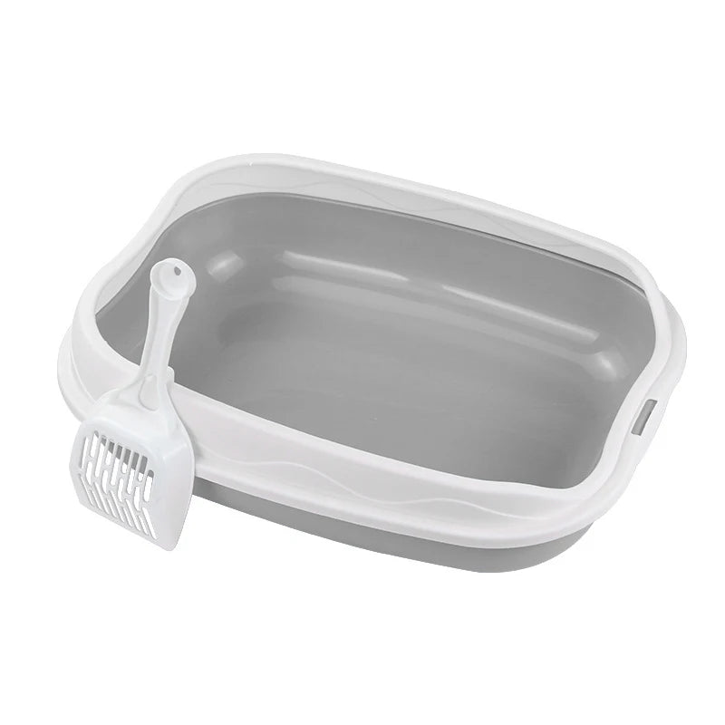 Gray pet litter box with a scoop on a white background