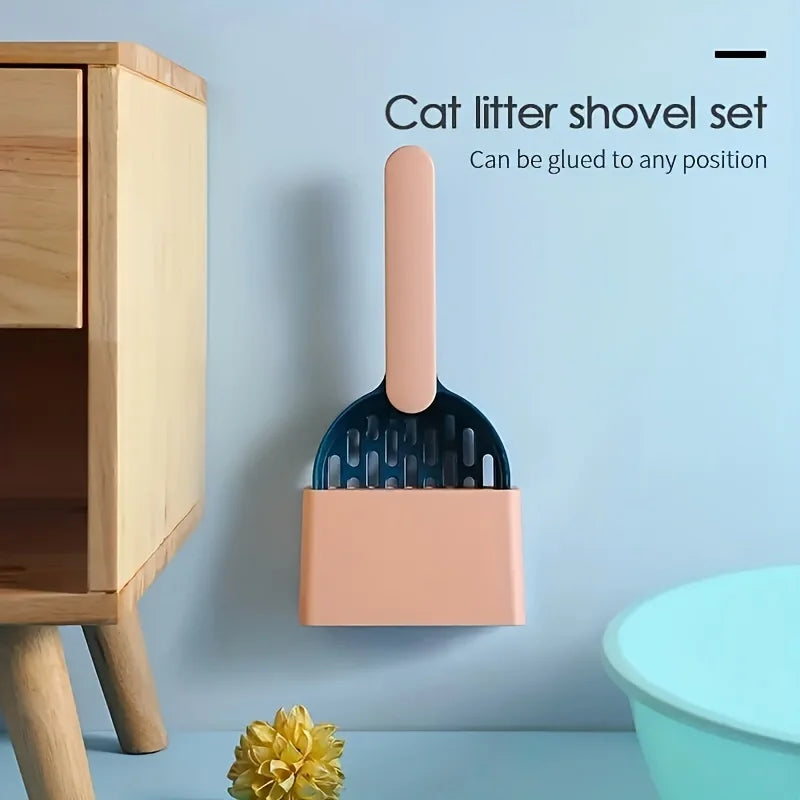 Cat litter shovel set with holder attached to a wooden cabinet against a light blue background.