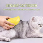 Cat being groomed with a yellow steamy cat brush on a light gray background