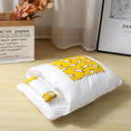White baby blanket with yellow dog pattern on a wooden floor
