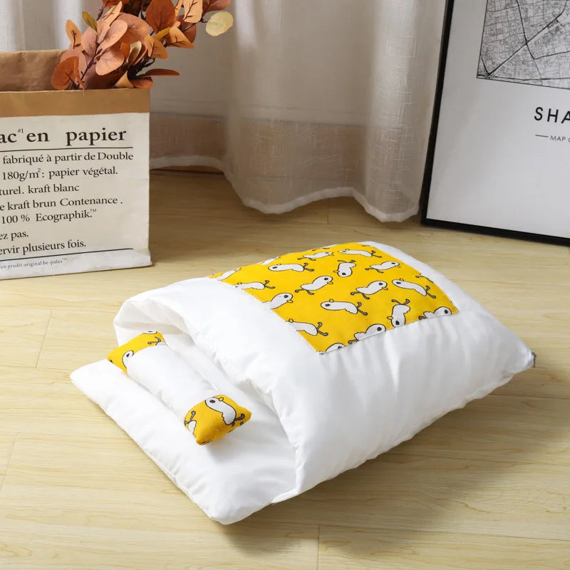 White baby blanket with yellow dog pattern on a wooden floor
