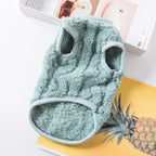 Green microfiber cleaning mitt on a white surface with a pineapple and books in the background