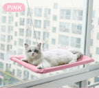 Cat lounging on a pink window hammock with a cityscape background