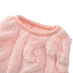 Close-up of a pink fluffy sweater on a white background