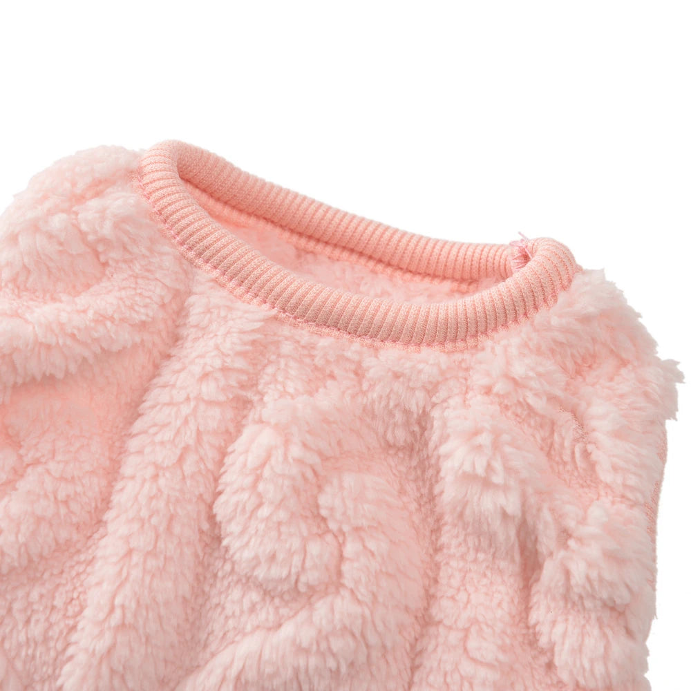 Close-up of a pink fluffy sweater on a white background