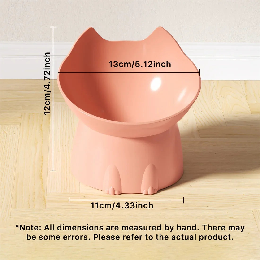 Pink cat-shaped pot with measurements on a wooden surface