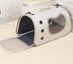 Pet carrier with clear window on a carpeted floor, featuring the HOMEFISH brand.