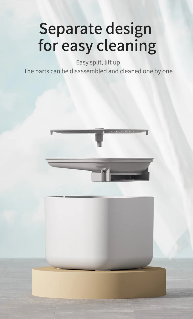 White kitchen appliance with a beige base on a light background, featuring text about easy cleaning.