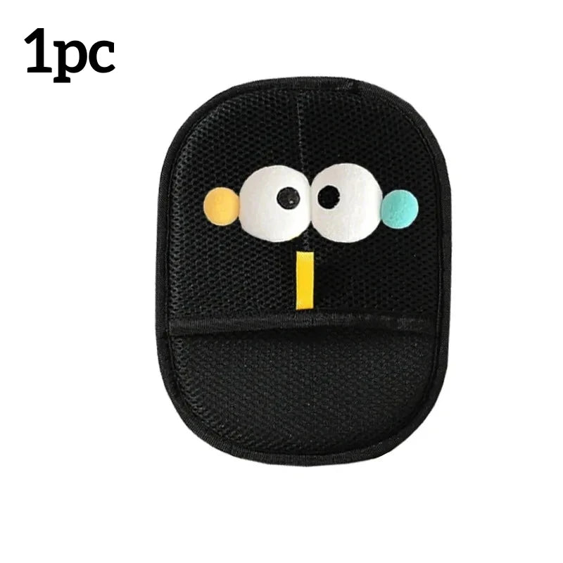 Black car seat cushion with cartoon face design on a white background