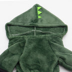 Green dinosaur-themed hooded towel on a white background