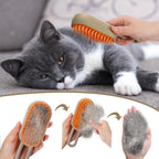 Cat being groomed with a brush, showing collected fur, on a gray surface.