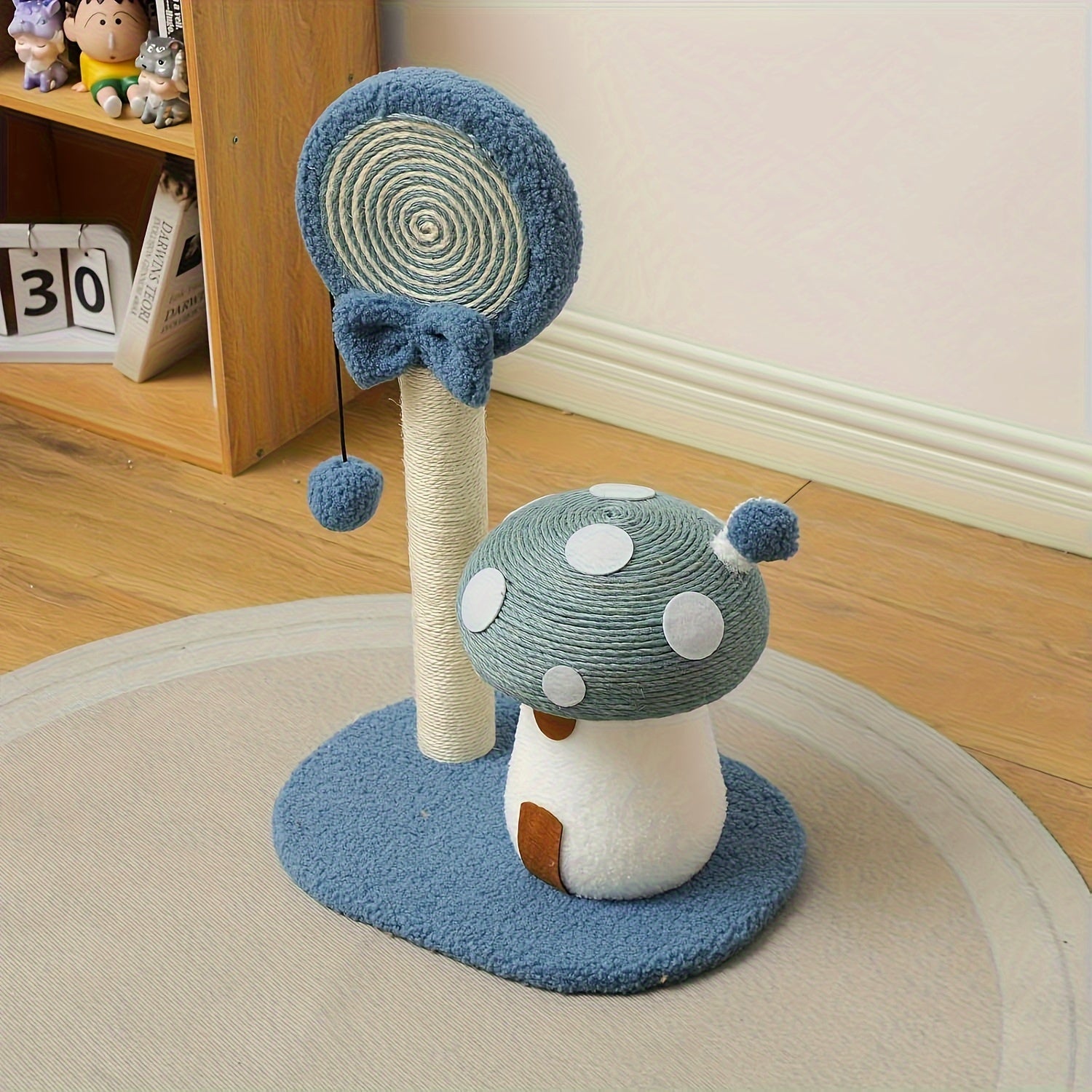 Cat toy with a mushroom design and scratching post on a wooden floor.