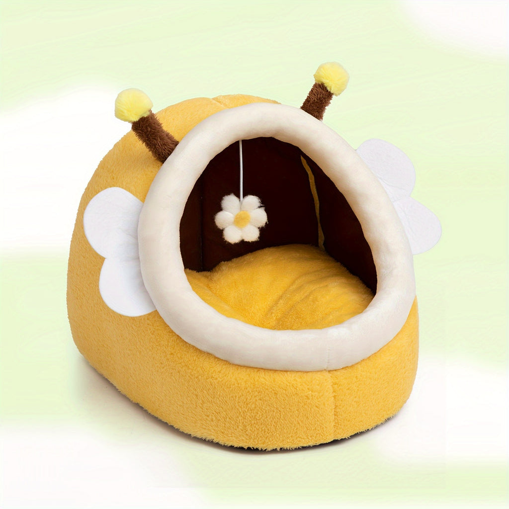 Yellow bee-shaped pet bed with antennae and a flower on a light green background