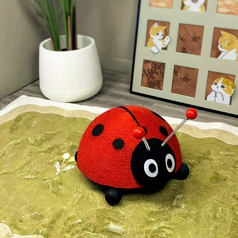 Red and black ladybug-shaped cat's scratchers on a textured surface with a plant and framed pictures in the background.