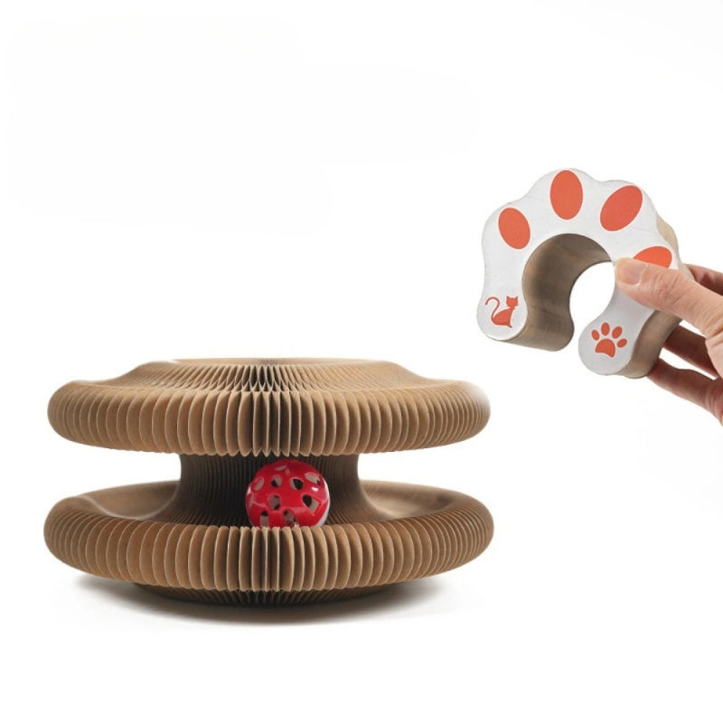 Cardboard cat toy with a red ball and paw-shaped magnet on a white background