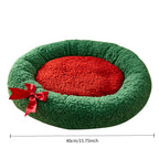 Green pet bed with a red interior and bow, dimensions displayed.